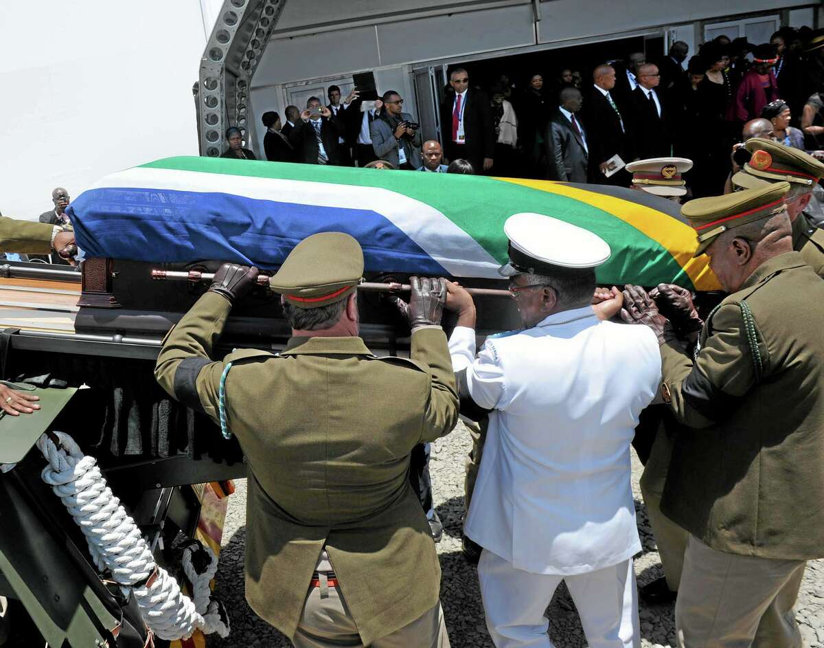 Former South African President Nelson Madela’s casket is loaded on a gun carrage following his funeral service in Qunu, South Africa, Sunday, Dec. 15, 2013. AP Photo/Elmond Jiyane