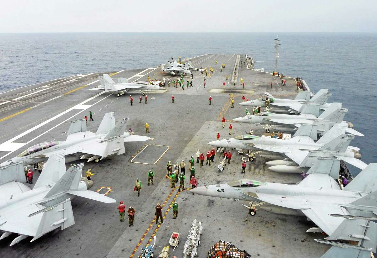 U.S. Navy FA-18 Hornets cram the flight deck of the USS George Washington during a joint military exercise with Japan in the Pacific Ocean near Japan's southernmost island of Okinawa Thursday, Nov. 28, 2013. The 13-day drill ended in the day as an air defense zone newly declared by China Saturday, Nov. 23 in the East China Sea has raised some tensions in the region. (AP Photo/Kyodo News) JAPAN OUT, MANDATORY CREDIT