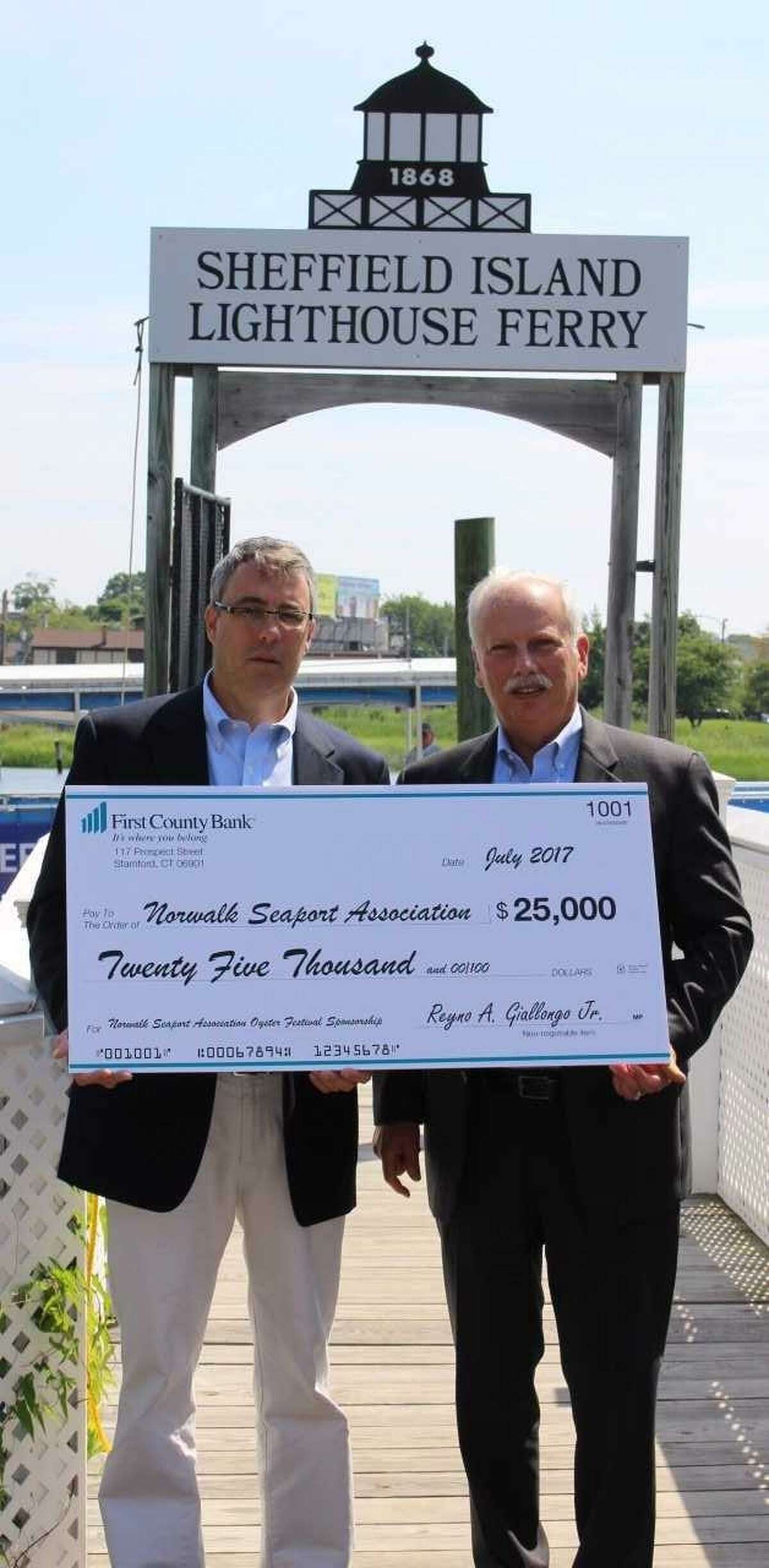 Mike Reilly, Norwalk Seaport Association president and Oyster Festival chairman, along with Reyno Giallongo, chairman and CEO, First County Bank. As the presenting sponsor, First County Bank presents their sponsorship check to the Norwalk Seaport Association for the 2017 Oyster Festival.