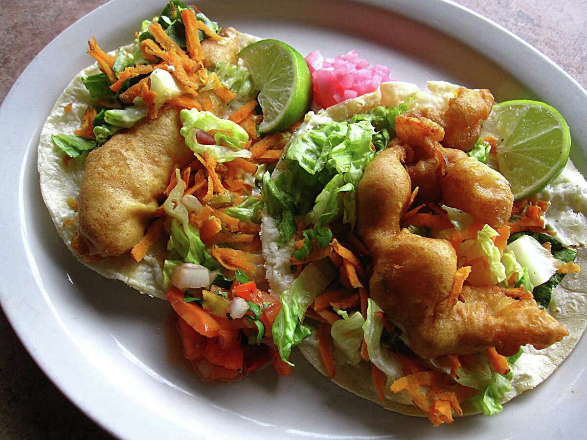 Fried Baja fish taco, left, and a fried Baja shrimp taco, both on corn tortillas, from El Siete Mares.