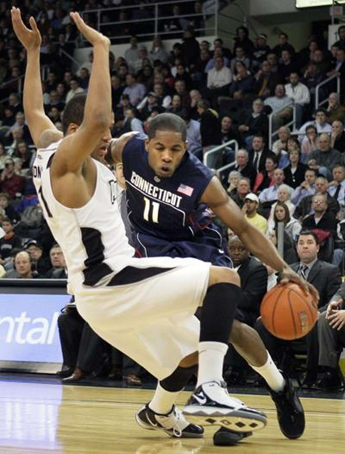 Connecticut's Jerome Dyson (11) drives against Providence's Duke Monday (1) during the first half Wednesday. (Associated Press)