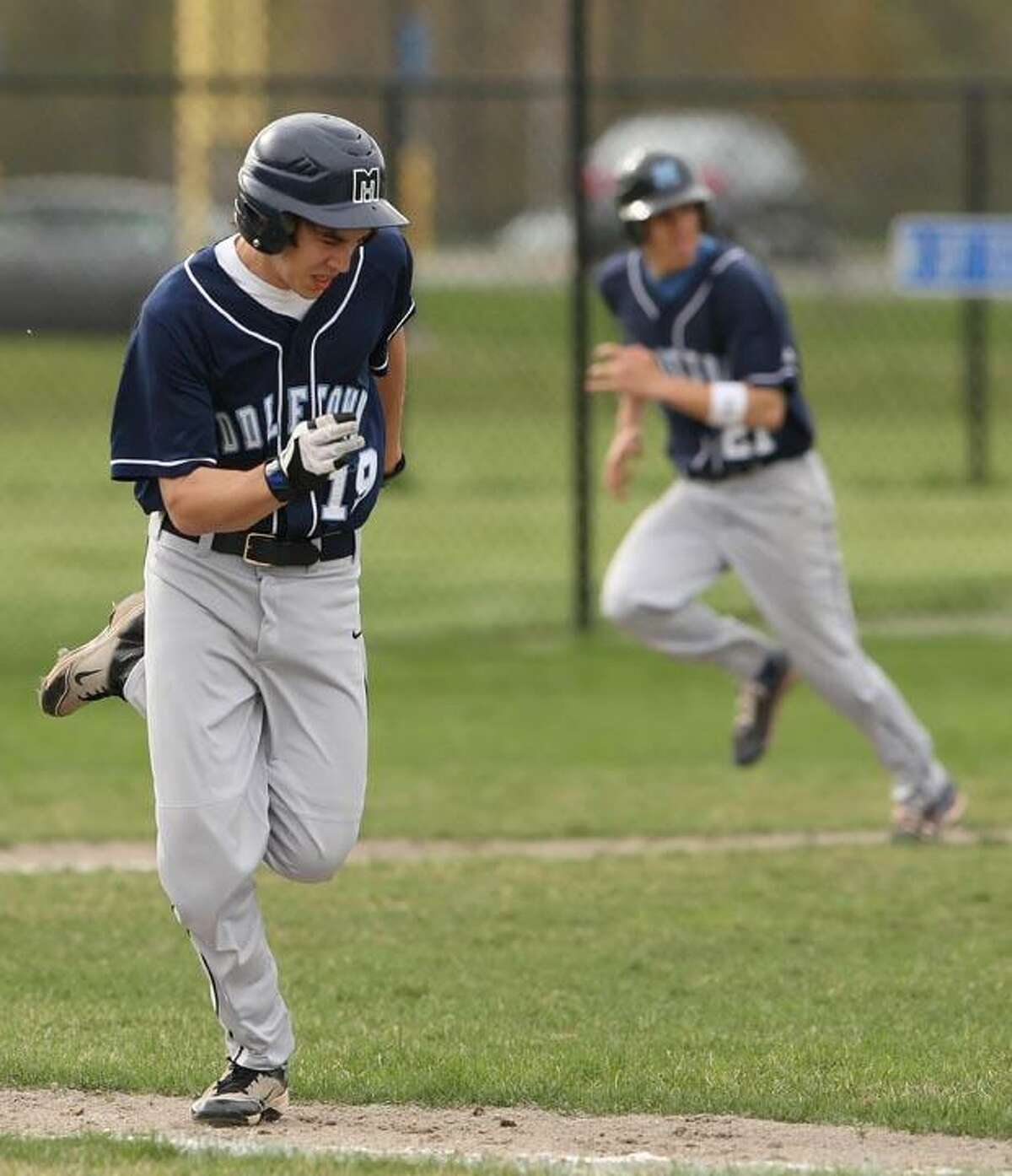 Todd Kalif/Special to The Press Another close miss as Middletown's Pat Michaud races to beat a third out throw at first while Josh Strohm races to the plate on Monday in Middletown baseball's 16-6 loss to Bristol Central.