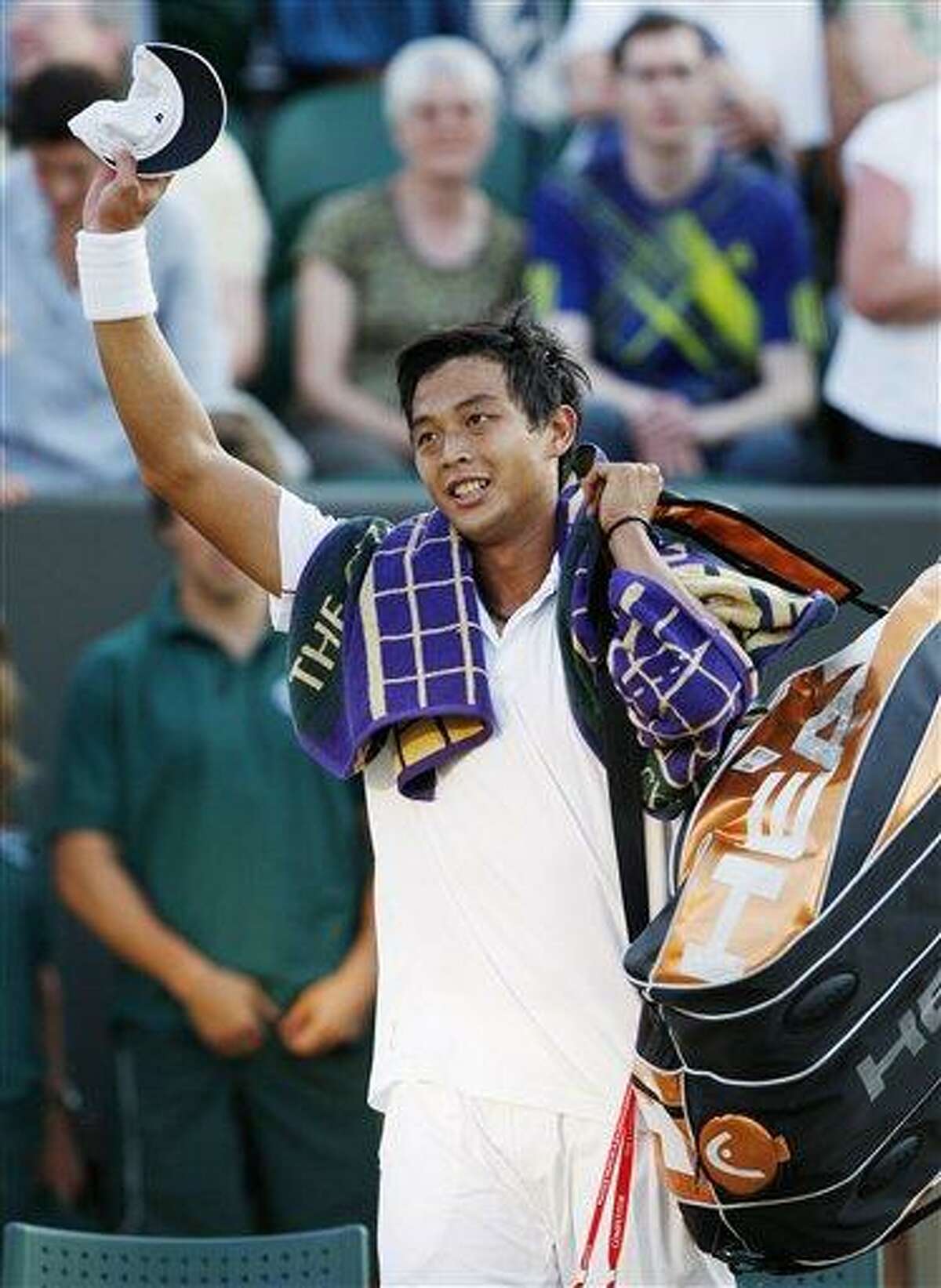 Taiwan's Lu Yen-Hsun waves to the crowd as he celebrates his win over Andy Roddick of the U.S. at the All England Lawn Tennis Championships at Wimbledon, Monday. (AP)