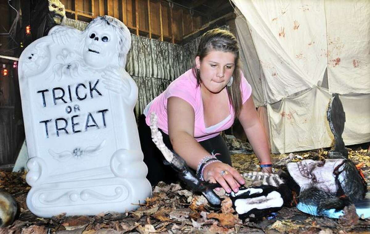 The Middletown Press 10.26.11 Middletown High sophomore Ashley Muzik and freshman Kelly Deegan hoist a giant spider in "The Graveyard" at the Middletown High School Haunted Boathouse which opens this weekend. To buy a print of this photo and more, visit the photo gallery at www.middletownpress.com
