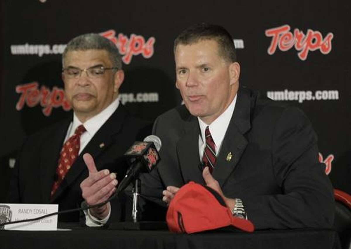 University of Maryland director of athletics Kevin Anderson, left, looks on as Randy Edsall speaks at a news conference after being introduced as the new head football coach at the school, Monday, Jan. 3, 2011, in College Park, Md. (AP Photo/Rob Carr)