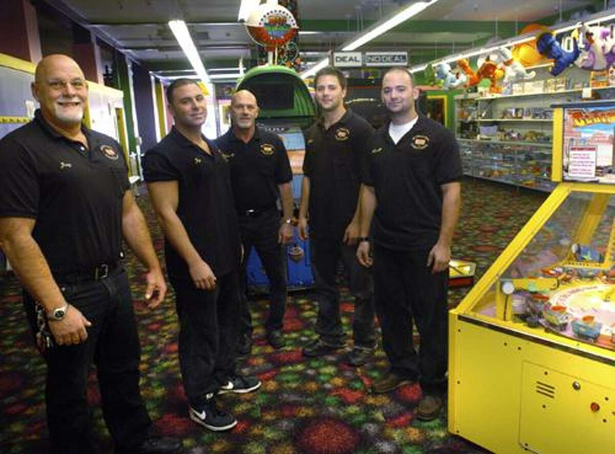 ** ADVANCE FOR SUNDAY OCT. 31 ** In this Oct. 25, 2010 photo, My Three Sons owner Jerry Petrini, left, Jay Petrini, second from left, general manager Matthew Bottone, third from left, Jerry Petrini Jr. second from right, and Matt Petrini pose in the store in Norwalk, Conn. (AP Photo/The Hour, Matthew Vinci)