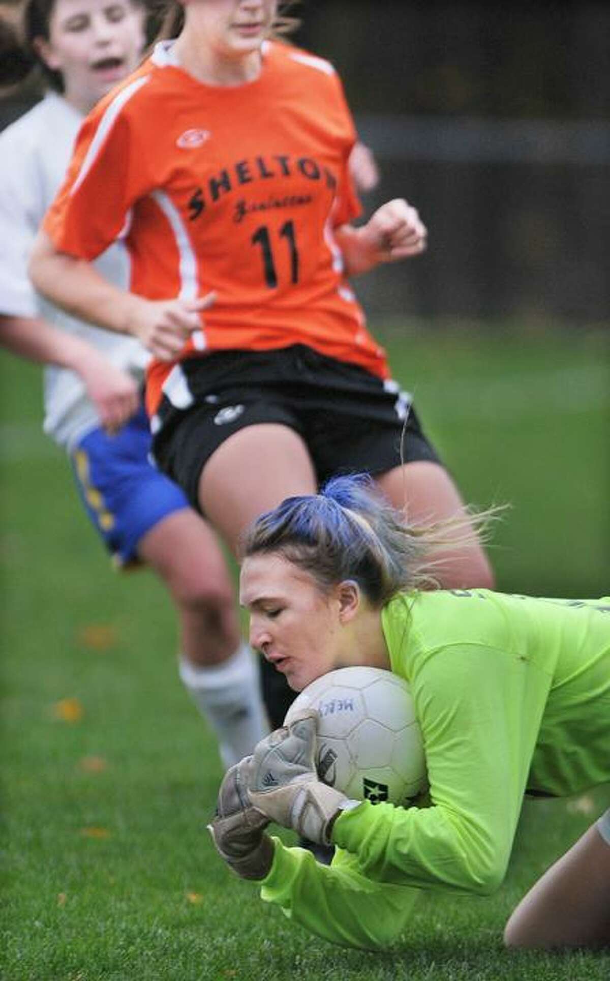 Mercy goalie, captain Katie Donnelly beats Shelton's Angela Ferro to the ball during senior night at Tiger Field in Middletown Friday. Shelton defeated Mercy 2-1. (Catherine Avalone