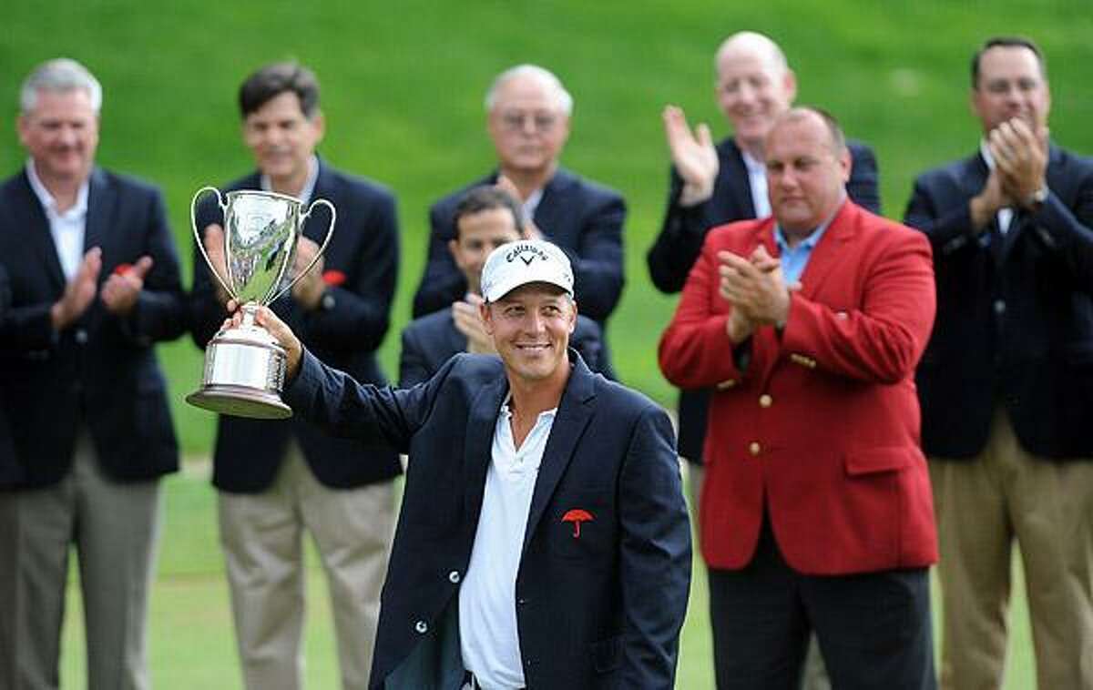 Fredrik Jacobson holds up the Championship Trophy after winning the 2011 Travelers Championship. Photo-Peter Casolino/New Haven Register