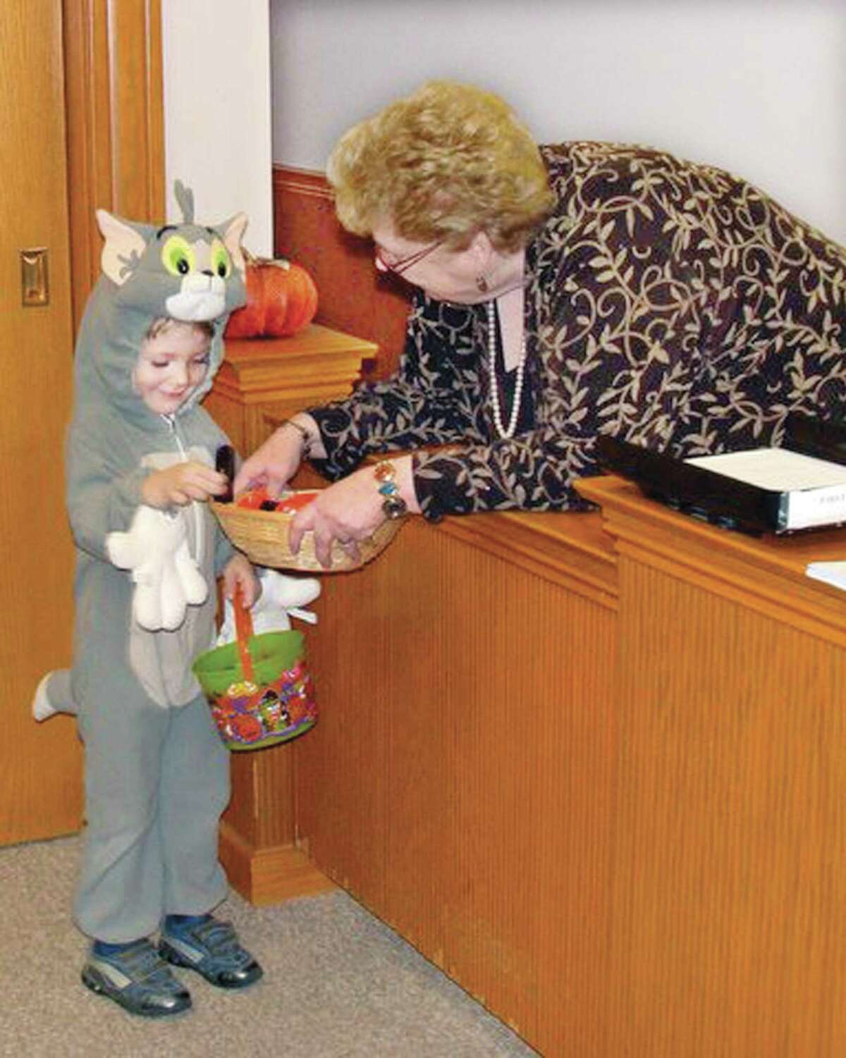 Photo courtesy Marcia Pendleton-Sacco 10.25.10 Three year old, Liam Walsh, of Cromwell gets candy from Re Matus, the secretary for Cromwell's First Selectman at Town Hall Pre-Halloween' Playtime, Party and Trick or Treat sponsored by the Cromwell Youth Services.