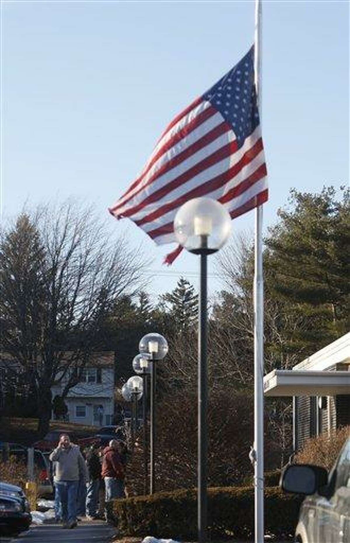 A flag flies at half-mast at a Plumbers and Pipefitters Local 777 training center where members gather for a meeting about the explosion at the Kleen Energy Systems power plant yesterday in Meriden Monday. ( AP Photo/Seth Wenig)