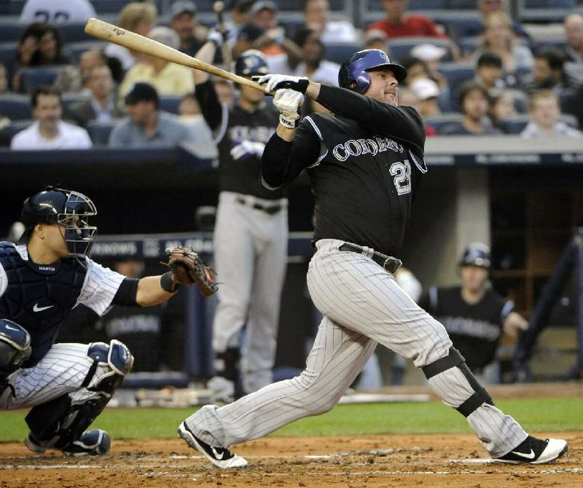 ASSOCIATED PRESS Colorado Rockies designated hitter Jason Giambi follows through on a home run during the second inning of an interleague game against the New York Yankees Friday at Yankee Stadium in New York. The Yankees lost 4-2.