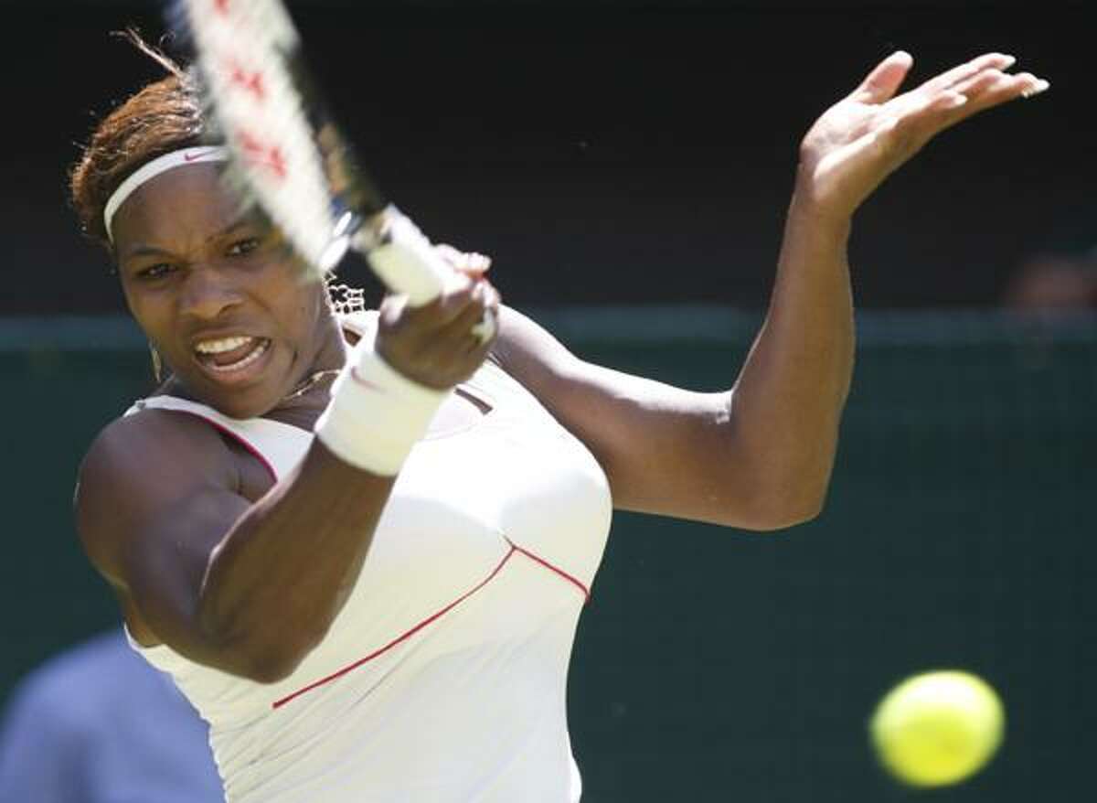 Defending champion Serena Williams returns to Michelle Larcher De Brito of Portugal, during their women's singles, first round match on the Centre Court at the All England Lawn Tennis Championships at Wimbledon, Tuesday. (AP)