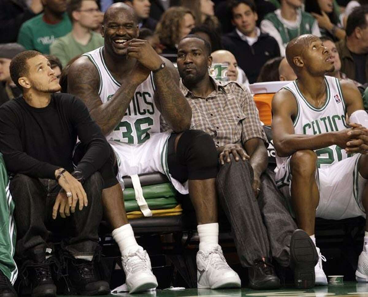 Boston Celtics' Shaquille O'Neal (36) sits on a pile of cushions as he talks with teammates Delonte West, left, and Kendrick Perkins, second from right, during the first half of an NBA preseason basketball game against the New Jersey Nets in Boston, Wednesday, Oct. 20, 2010. At right is Ray Allen. (AP Photo/Mary Schwalm)