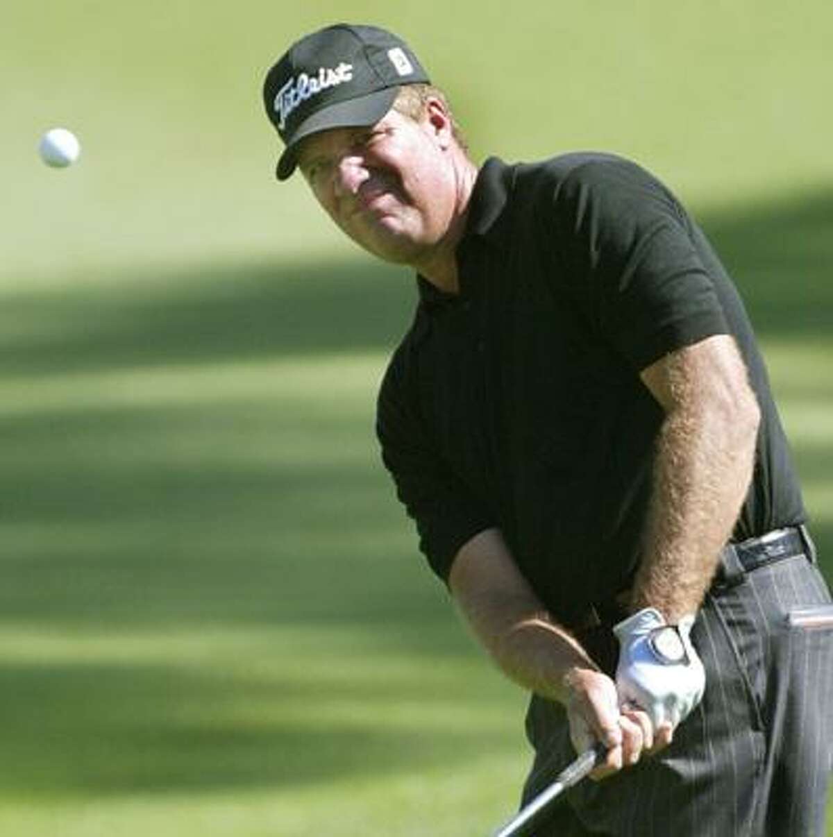 Steve Elkington, of Australia, chips to the green on the second hole during the third round of the Players Championship, Saturday, March 27, 2004, in Ponte Vedra Beach, Fla. (AP)