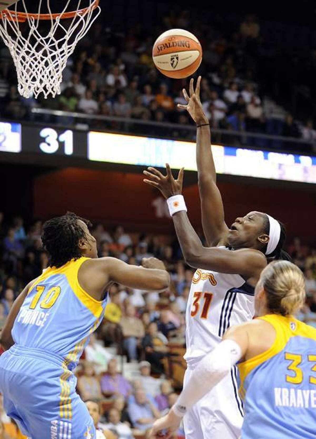 Connecticut Sun's Tina Charles shoots over Chicago Sky's Epiphanny Prince during the first half of their WNBA basketball game in Uncasville, Conn., on Sunday, June 19, 2011. (AP Photo/Fred Beckham)