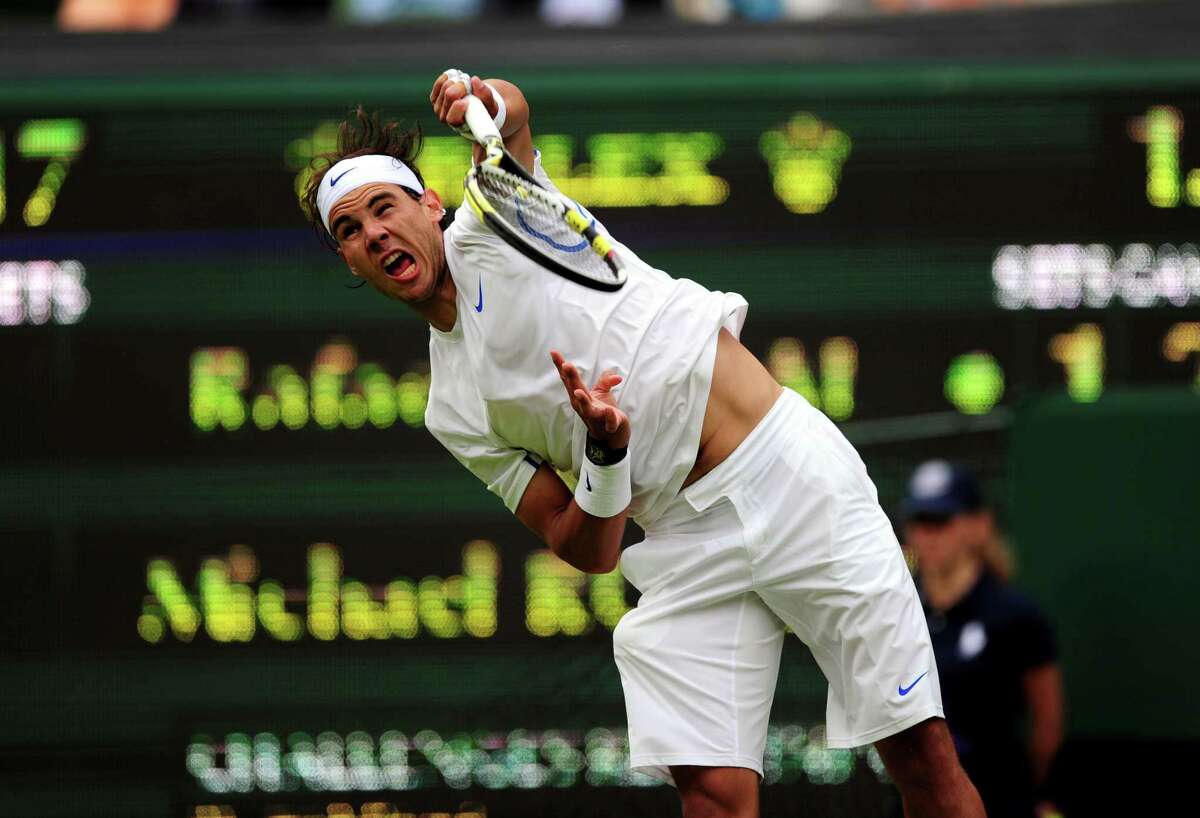 Tennis - 2011 Wimbledon Championships - Day One - The All England Lawn Tennis and Croquet Club. Spain's Rafael Nadal in action against USA's Michael Russell during day one of the 2011 Wimbledon Championships at the all England Lawn Tennis and Croquet Club, Wimbledon. URN:11008547 (Press Association via AP Images)