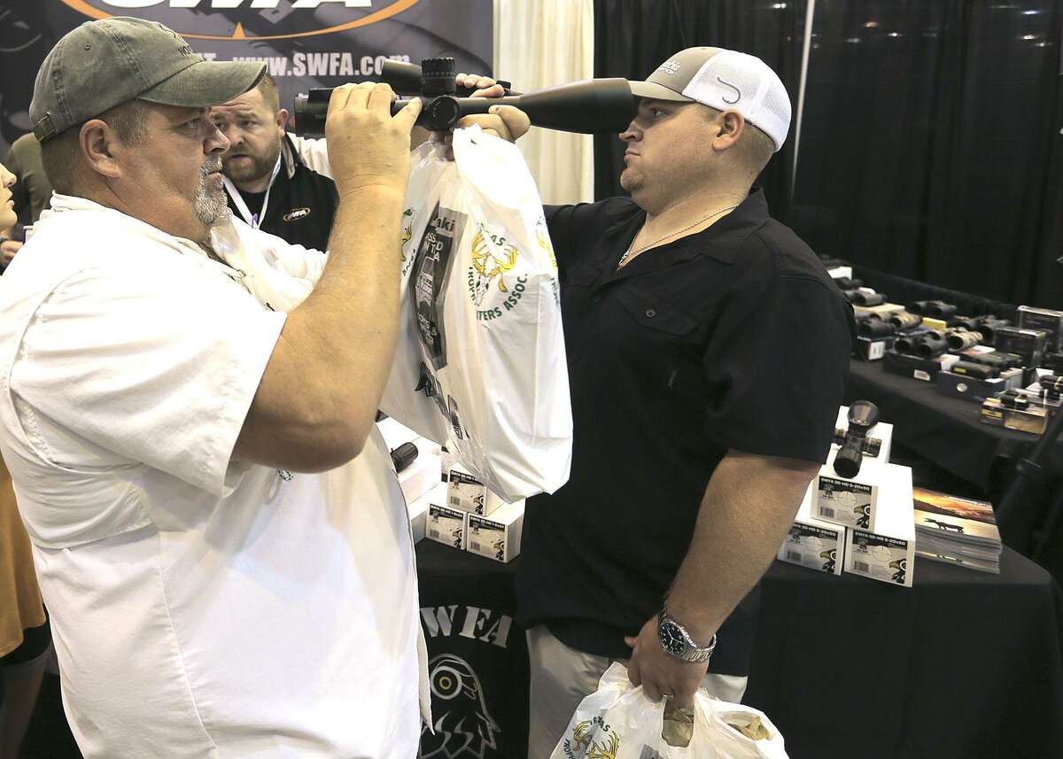 Jordan, left, and Justin Smith of Spring, Texas check out scopes from SWFA during the Hunter's Extravaganza sponsored by the Texas Trophy Hunters Association at NRG Center on Saturday, Aug. 13, 2016, in Houston. ( Elizabeth Conley / Houston Chronicle )