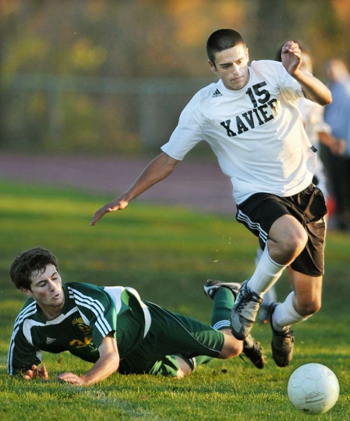 Xavier senior forward Steve Charton battles for posession with Hamden junior midfielder Connor Walsh during a home match for the Falcons. Hamden defeated Xavier 1-0. (Catherine Avalone