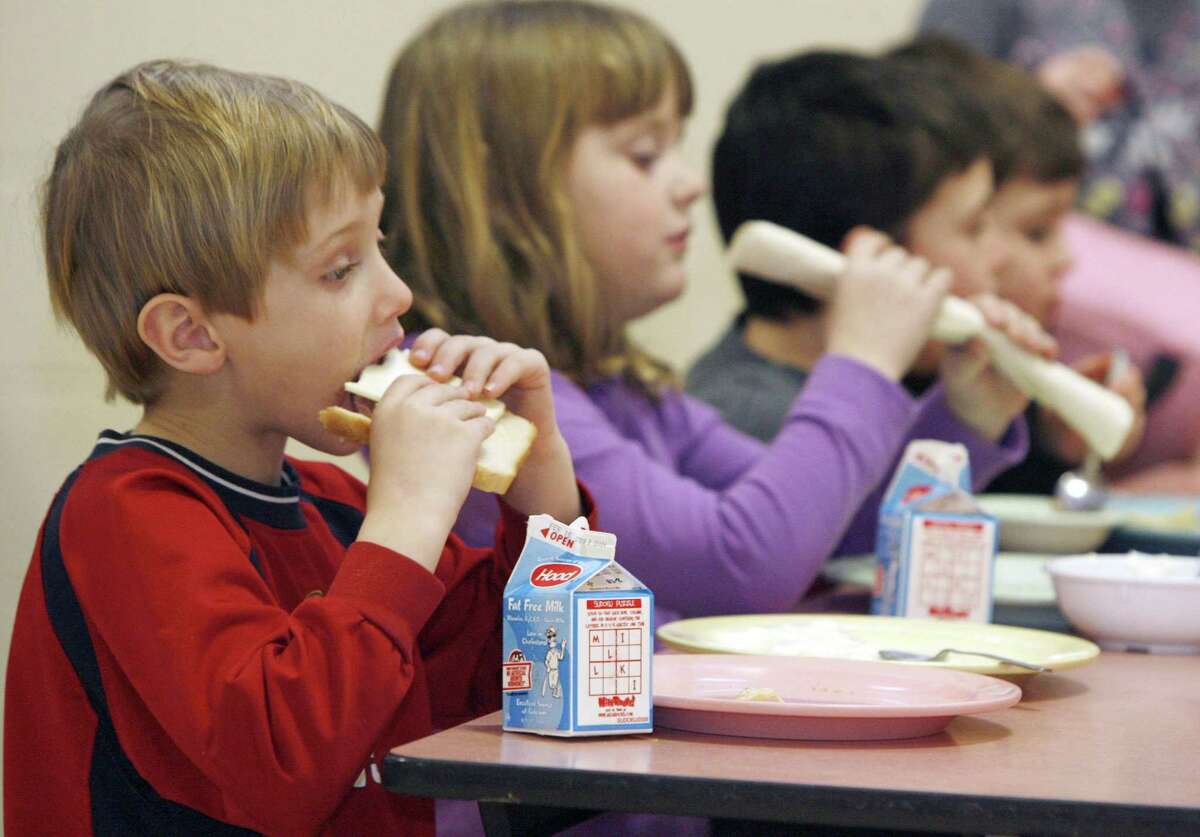 In this Feb. 3, 2010, file photo, students eat lunch at Sharon Elementary School in Sharon, Vt. A new $250,000 federal grant will help New England states get more locally raised food into their colleges, schools, hospitals and other institutions. (AP Photo/Toby Talbot)