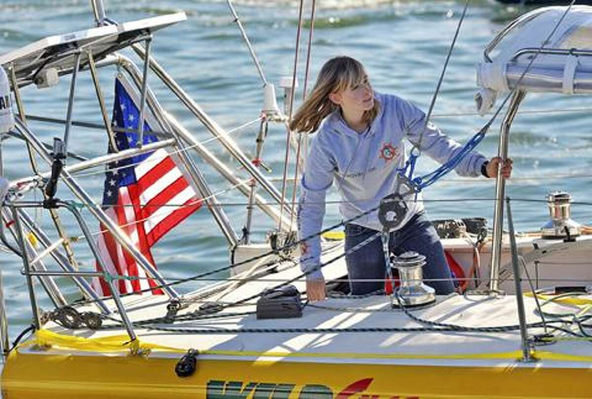 In this Jan 23 file photo, Abby Sunderland, 16, looks out from her sailboat, Wild Eyes, as she leaves for her world record attempting journey at the Del Rey Yacht Club in Marina del Rey, Calif. Sunderland who was feared lost at sea while sailing solo around the world has been found alive and well, adrift in the southern Indian Ocean with rescue boats headed toward her, officials said. (AP)