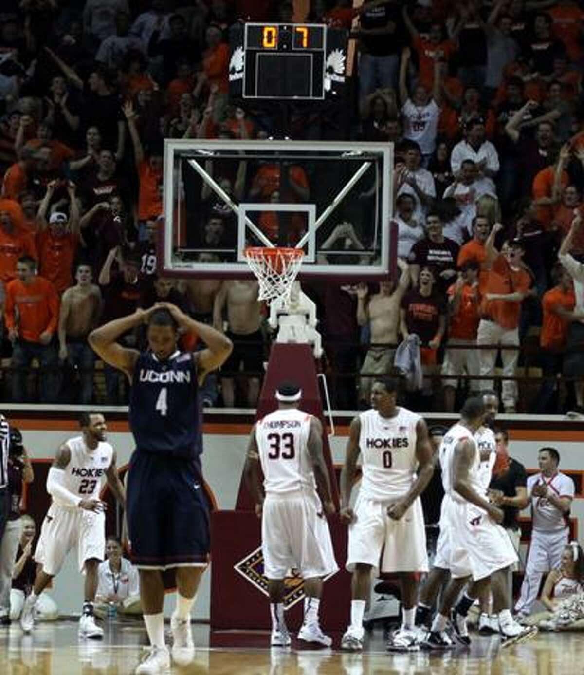 Connecticut's Jamal Coombs-McDaniel (4) walks away as Virginia Tech players celebrate a defensive stop and foul with less than a second left in a second-round NIT college basketball game in Blacksburg, Va., Monday. (Associated Press)