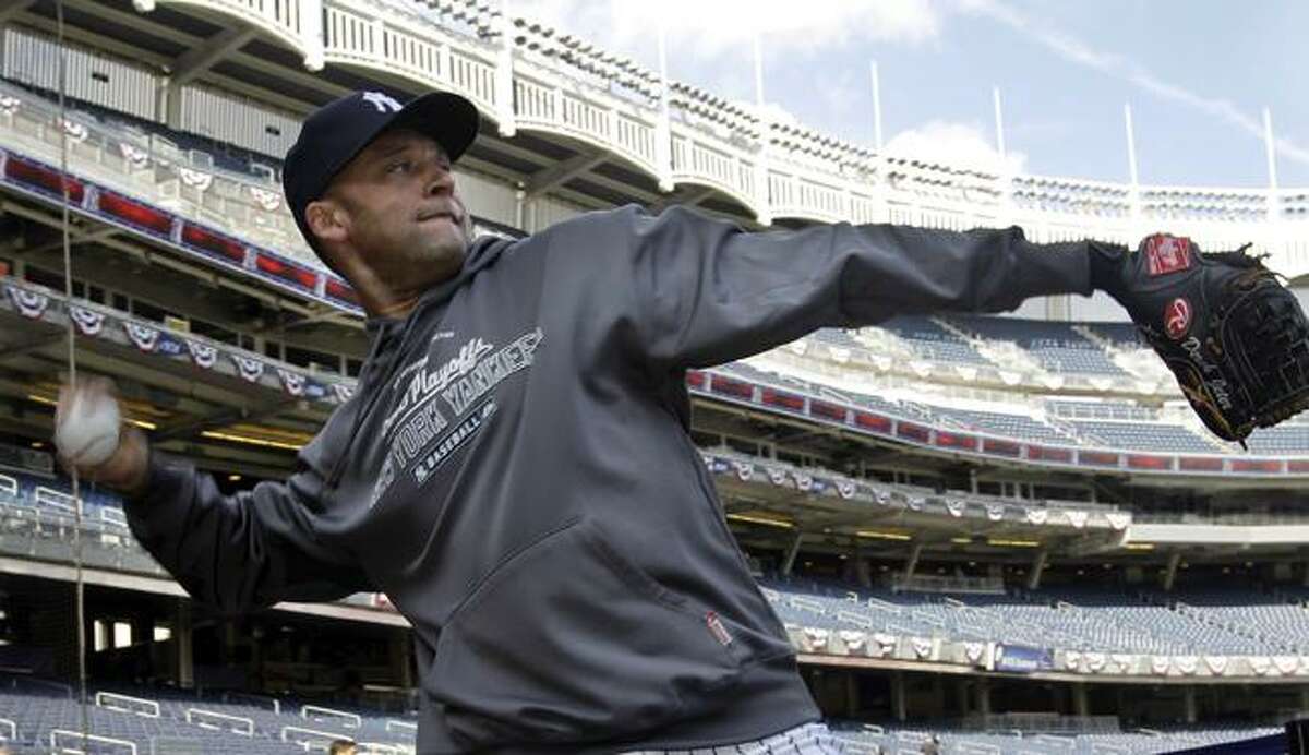 New York Yankees shortstop Derek Jeter tosses in the area behind home plate during a baseball workout at Yankee Stadium in New York, Tuesday. The Yankees face the Texas Rangers Friday in the American League Championship. (AP Photo/Kathy Willens)
