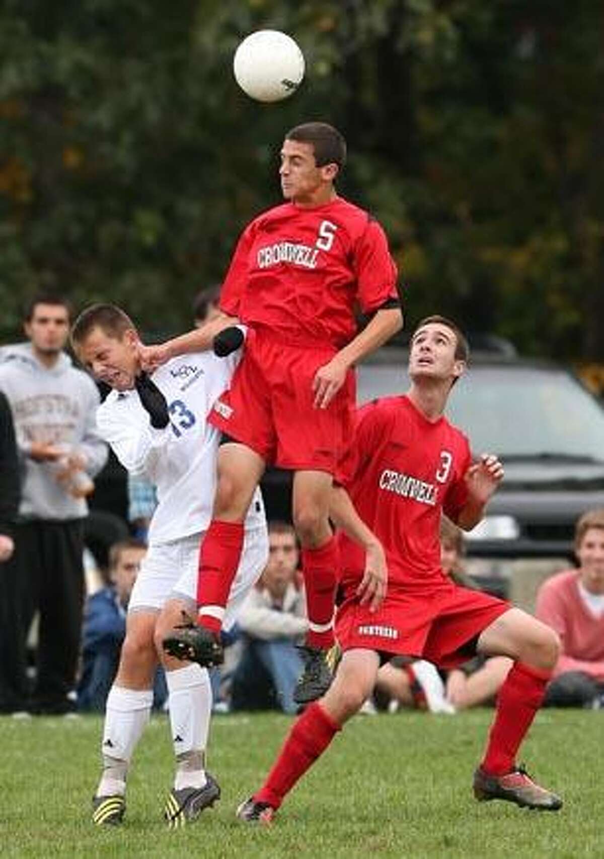 Cromwell's James Iannicelli out-jumps Old Lyme's Jeff Winters to head the ball Thursday. (Todd Kalif