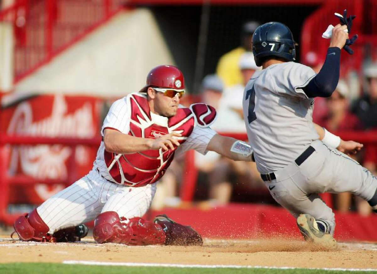 ASSOCIATED PRESS South Carolina catcher Robert Beary (4) puts the tag on Connecticut's Nick Ahmed (7) in the second inning of the first game of a best-of-three NCAA college baseball super regional at Carolina Stadium, Saturday in Columbia, S.C. The Huskies lost 5-1.