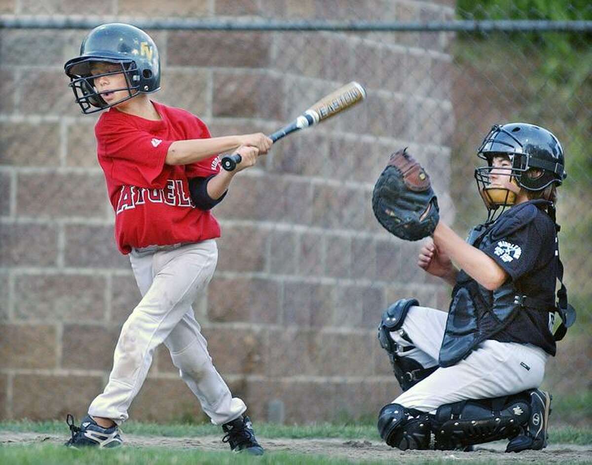 Elks catcher Cameron Cietek keeps an eye on the ball as Frank & Gloria's Angels Sean Black is at bat. The Elks defeated the Angels 13-11. (Catherine Avalone / Middletown Press)
