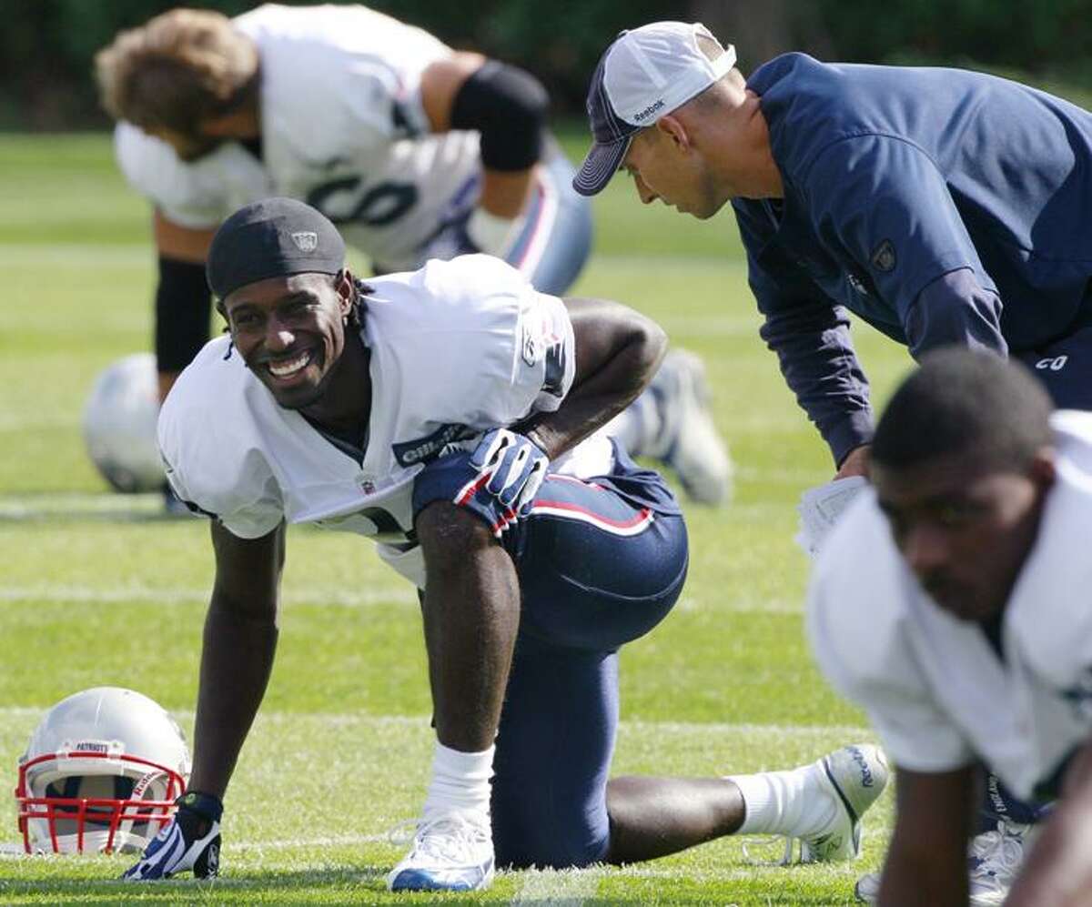 New England Patriots wide receiver Deion Branch, left, talks with wide receiver coach Chad O'Shea right, during NFL football practice in Foxborough, Mass., Tuesday. Branch, the former Super Bowl MVP wide receiver with the Patriots, was traded Monday night from the Seattle Seahawks to New England. (AP Photo/Charles Krupa)