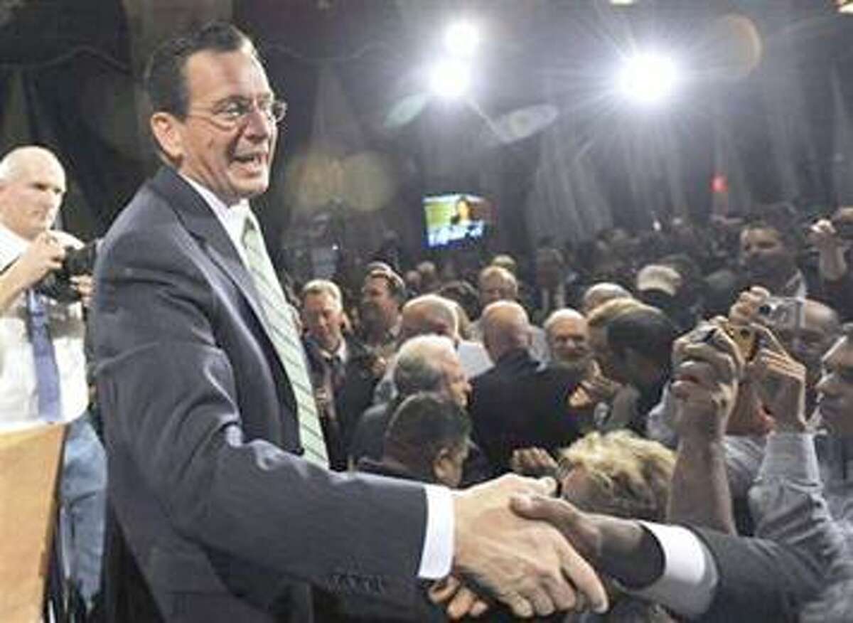 Governor-elect Dan Malloy shakes hands with supporters in Hartford earlier this month.