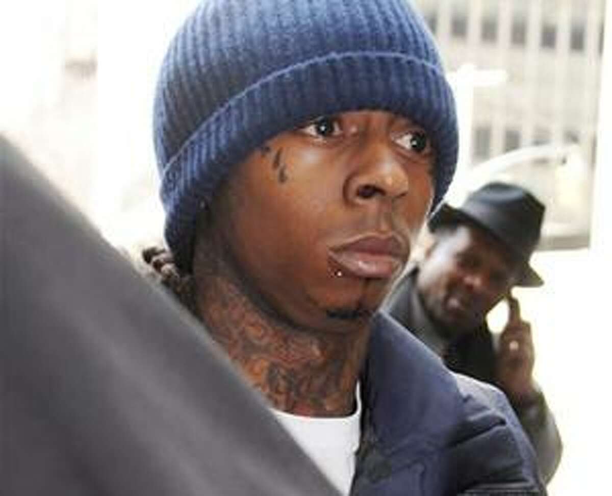 (AP) In this Feb. 9 photo, rapper Lil Wayne enters Manhattan criminal court in New York. The Grammy Award Winning performer will be the latest in a string of rappers to go to jail after rising to fame, and the latest celebrity inmate to test the line between affording special treatment and recognizing potential risks to high-profile convicts.