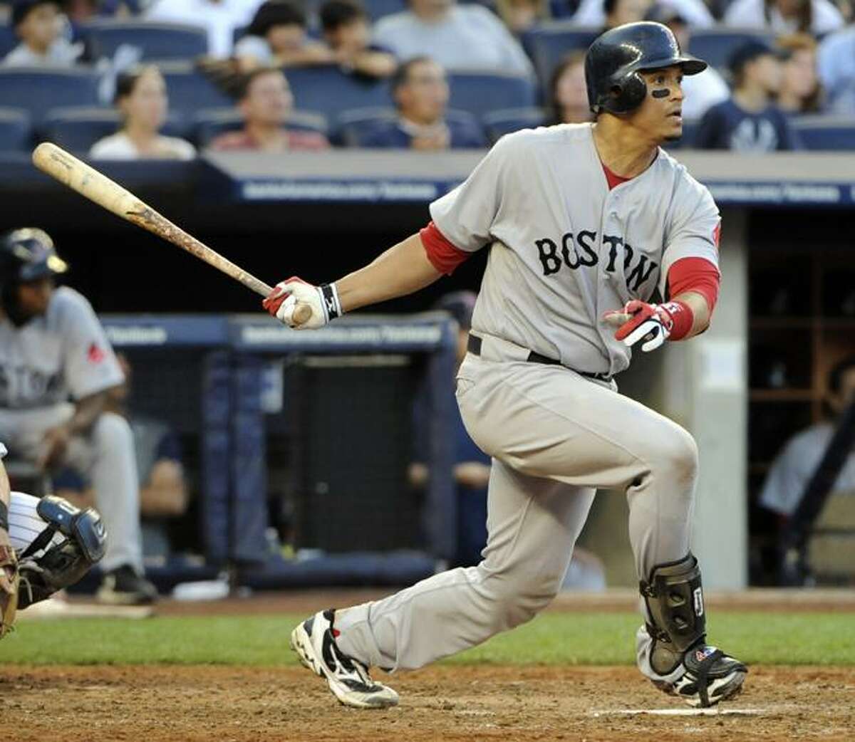 FILE - This Sept. 25, 2010, file photo shows Boston Red Sox batter Victor Martinez following through on a home run during the seventh inning of a baseball game against the New York Yankees, at Yankee Stadium in New York. A person familiar with the agreement tells The Associated Press that catcher Martinez and the Detroit Tigers have reached a preliminary agreement on a $50 million, four-year contract. The person spoke on condition of anonymity Tuesday, Nov. 23, 2010, because the deal, which is subject to a physical, had not yet been announced. (AP Photo/Bill Kostroun, File)