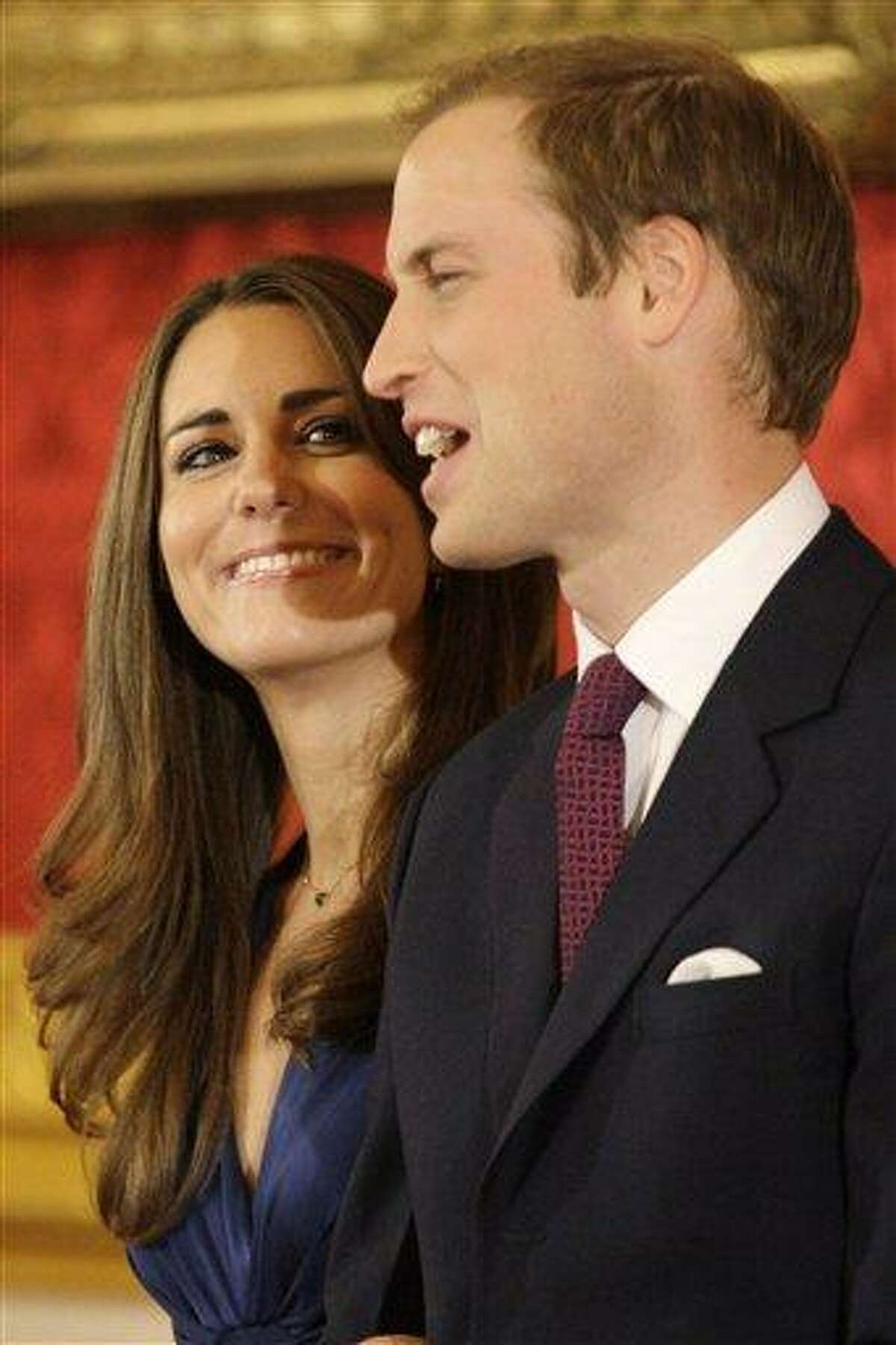Britain's Prince William and his fiancee Kate Middleton pose for the media at St. James's Palace in London after announcing their marriage, London, Tuesday, Nov. 16, 2010. The couple are to wed in 2011.(AP Photo/Sang Tan)