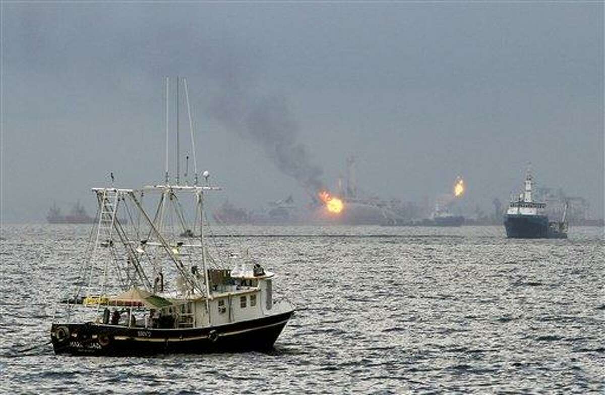 A commercial fishing vessel assisting in the containment of oil leaking from the Deepwater Horizon oil wellhead sails towards the site of the leak on the Gulf of Mexico near the coast of Louisiana Thursday, July 15, 2010. (AP Photo/Patrick Semansky)