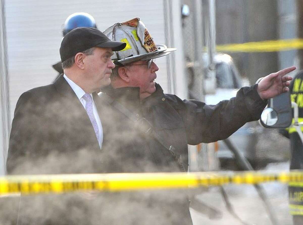 New Haven Fire Chief Michael Grant, right, shows New Haven John DeStefano Jr. around the house that was engulfed in flames earlier Wednesday morning. (Brad Horrigan/New Haven Register)