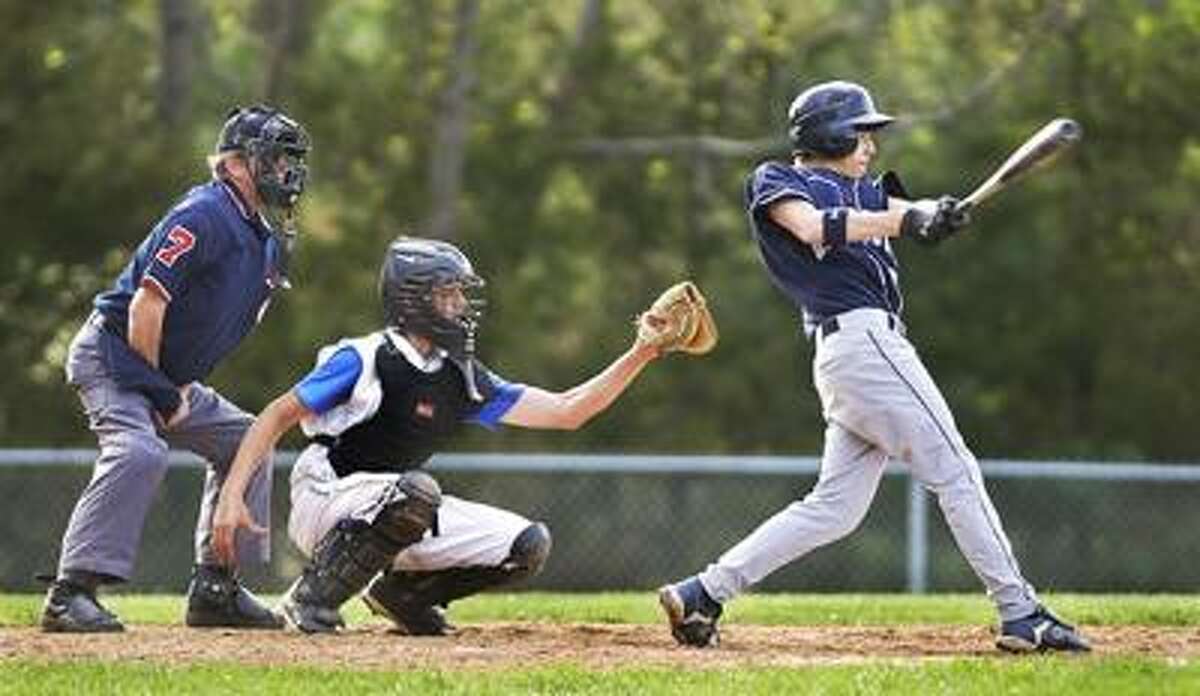 Middletown's Jason Sinagra connects with a pitch last season as Vinal's Mackenzie Engel watches from behind the plate. (Catherine Avalone / Middletown Press)
