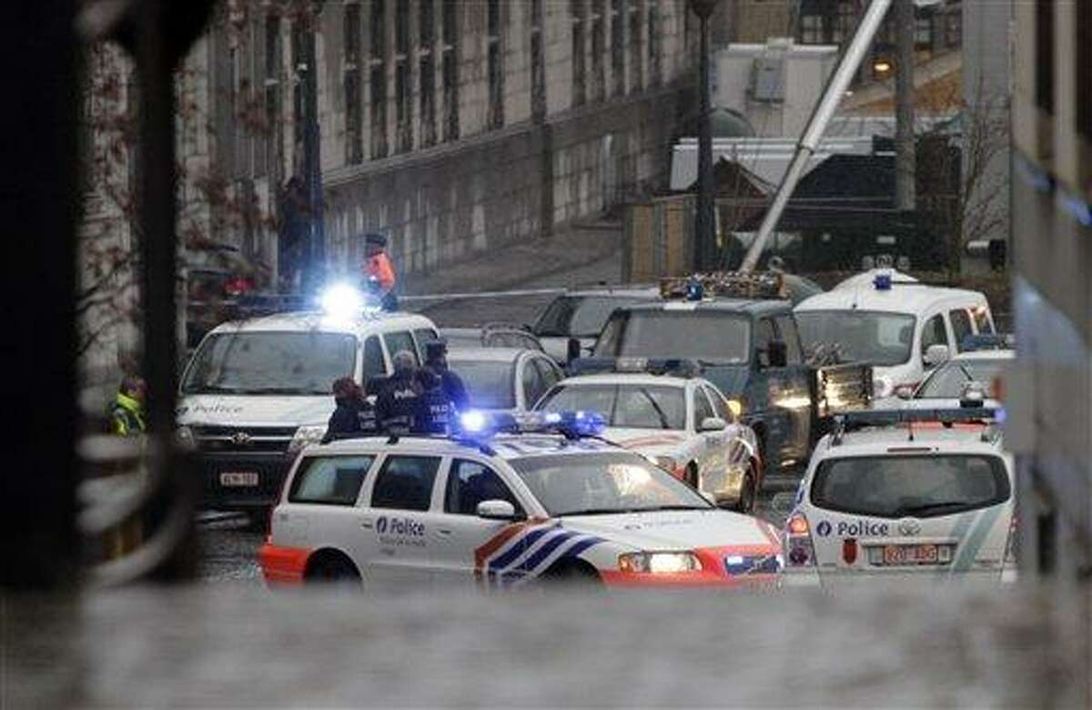 Ambulances are seen at the scene of incident in Liege, Belgium, Tuesday. Belgian news organizations are reporting that two people were killed and at least 10 wounded when three men attacked a crowd in the eastern Belgian city with hand grenades and gunfire. Associated Press