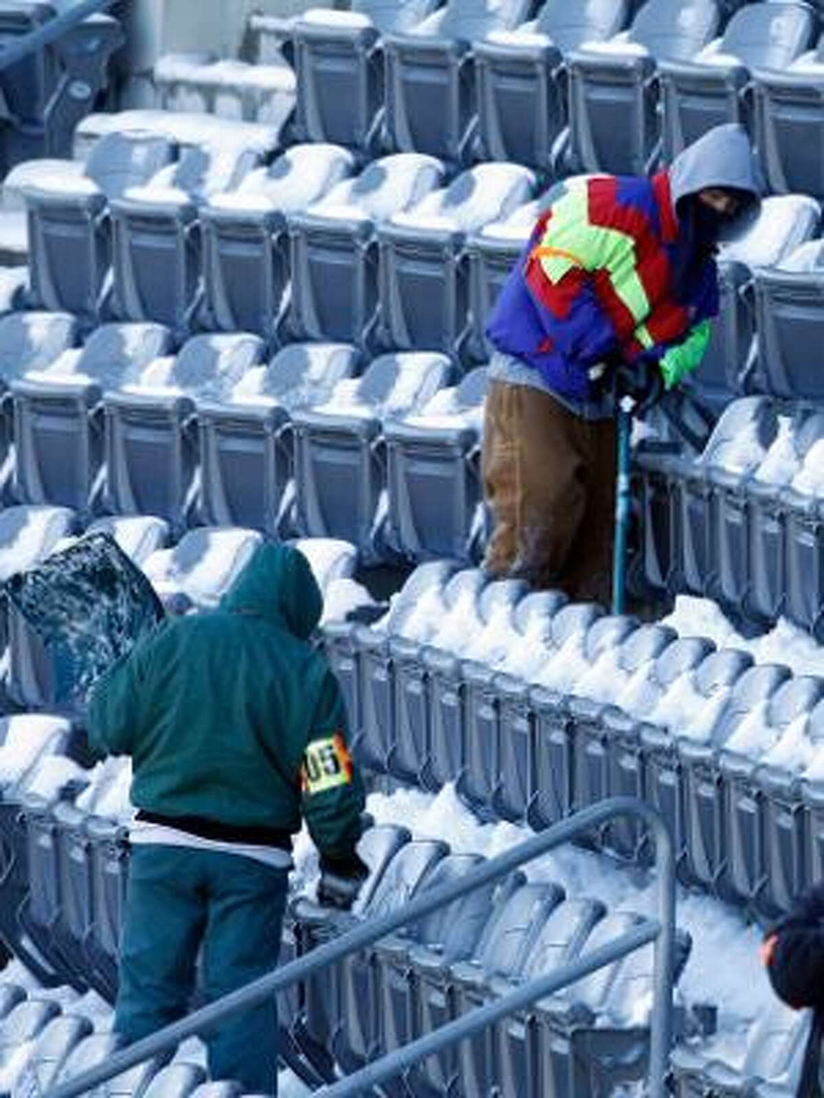AP Work crews remove snow from the stands of Lincoln Financial Field, home of the Philadelphia Eagles, in Philadelphia on Monday. A winter storm resulted in the postponement of the Minnesota Vikings-Eagles game from Sunday night to Tuesday night.