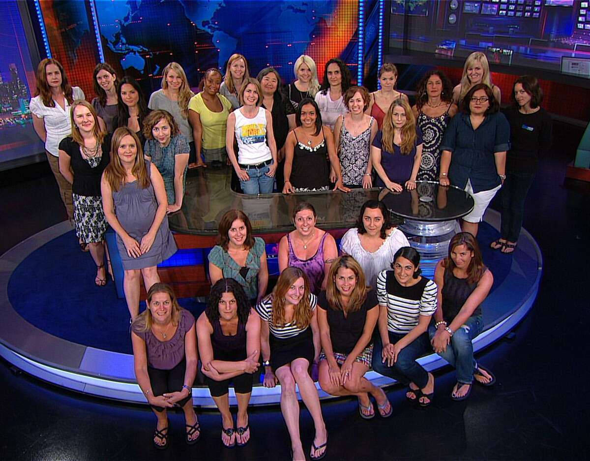 In this undated publicity image released by Comedy Central, female staffers from the Comedy Central show "The Daily Show with Jon Stewart," are shown on the set in New York. (AP Photo/The Daily Show with Jon Stewart, Comedy Central)