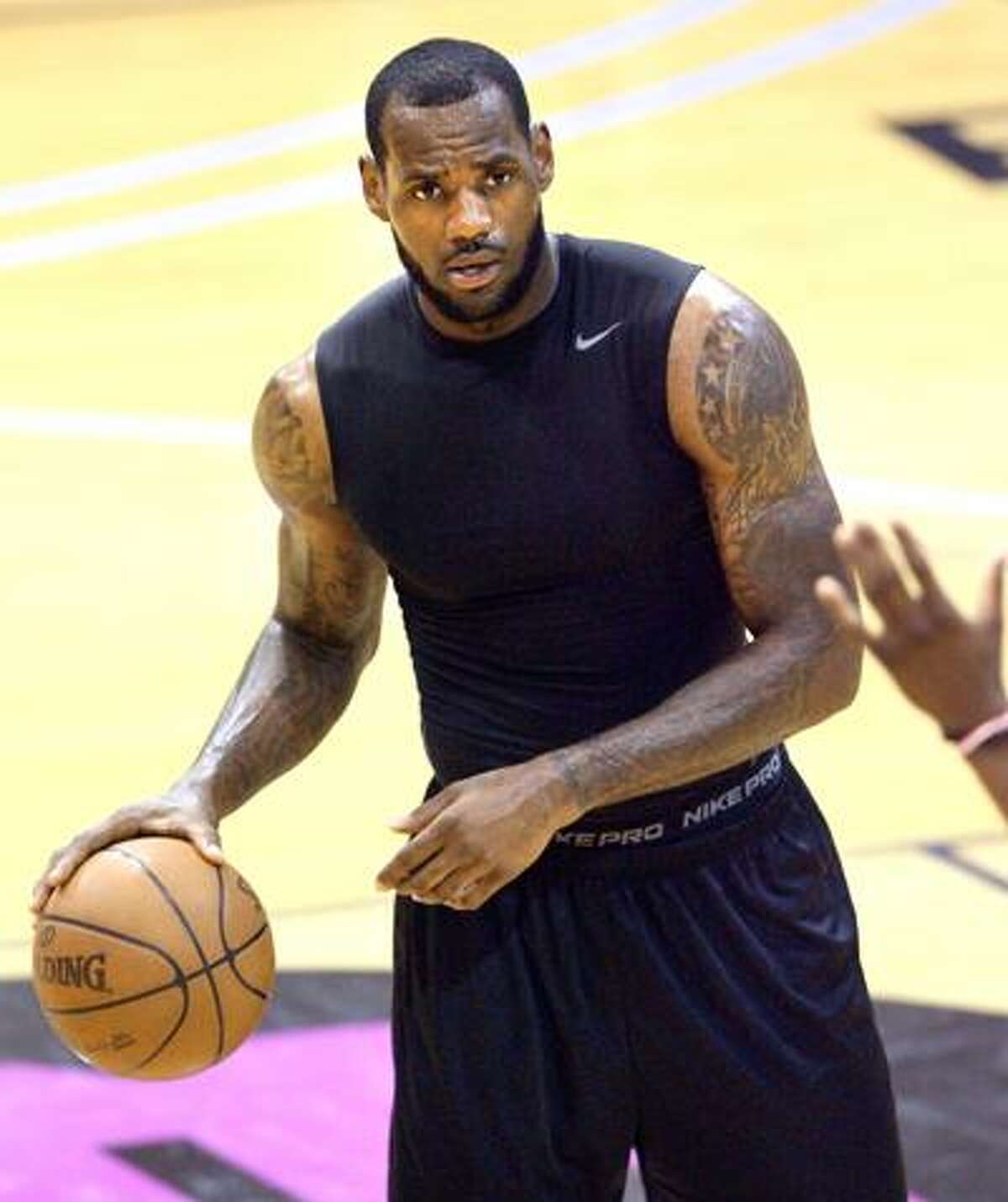 LeBron James takes part in evening workout games with high school basketball players at his skills academy Tuesday in Akron, Ohio. James, a free agent, is being courted by several NBA teams. (AP)