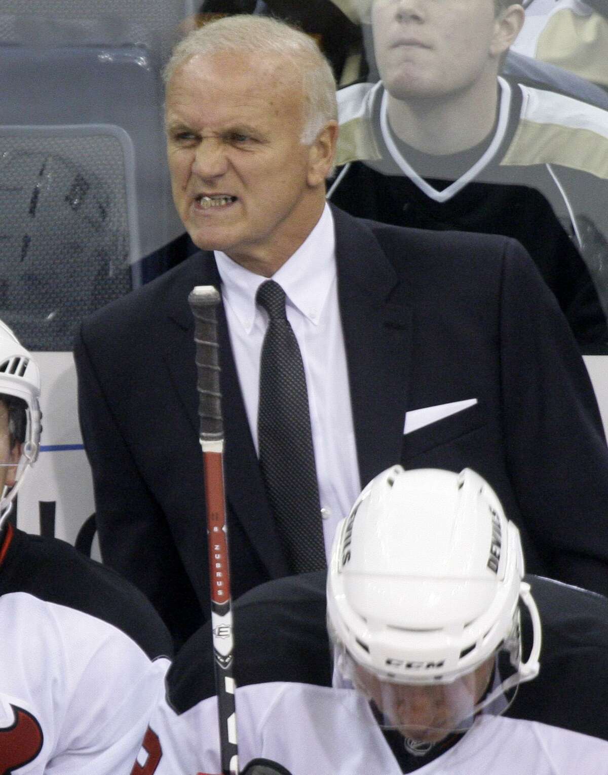 AP Photo/Gene J. Puskar New Jersey Devils coach Jacques Lemaire grimaces behind his bench during the first period of a 4-1 win over the Pittsburgh Penguins. The Devils have fired rookie coach John MacLean and brought back Jacques Lemaire to replace him.