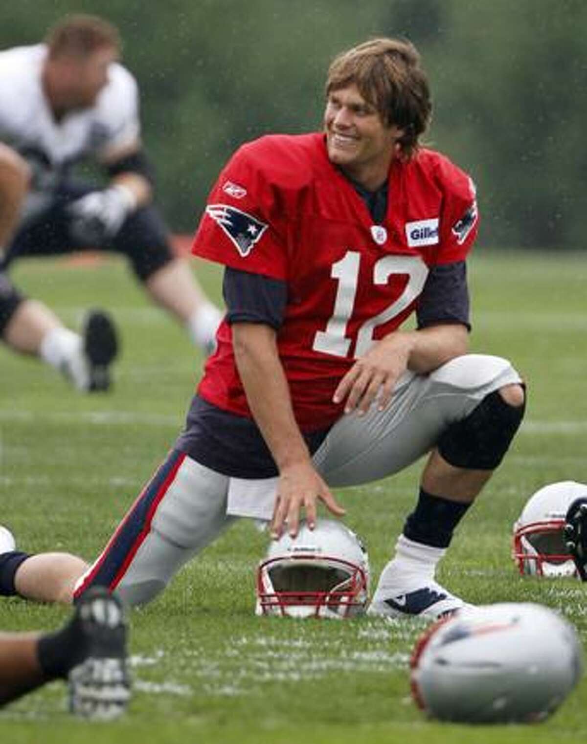 New England Patriots Tom Brady stretches during practice before