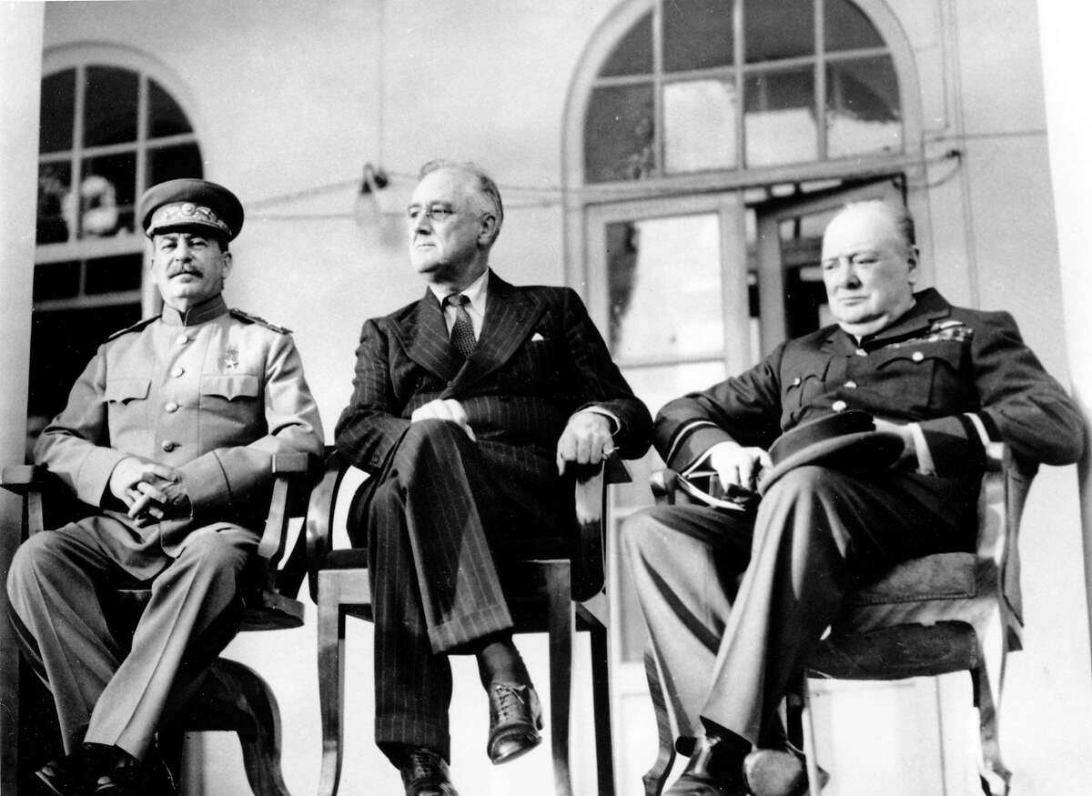 In this Nov. 28, 1943 file photo, Soviet Union Premier Josef Stalin, U.S. President Franklin D. Roosevelt, center, and British Prime Minister Winston Churchill sit together during the Tehran Conference in Tehran, Iran. The three leaders, meeting for the first time, discussed Allied plans for the war against Germany and for postwar cooperation in the United Nations.