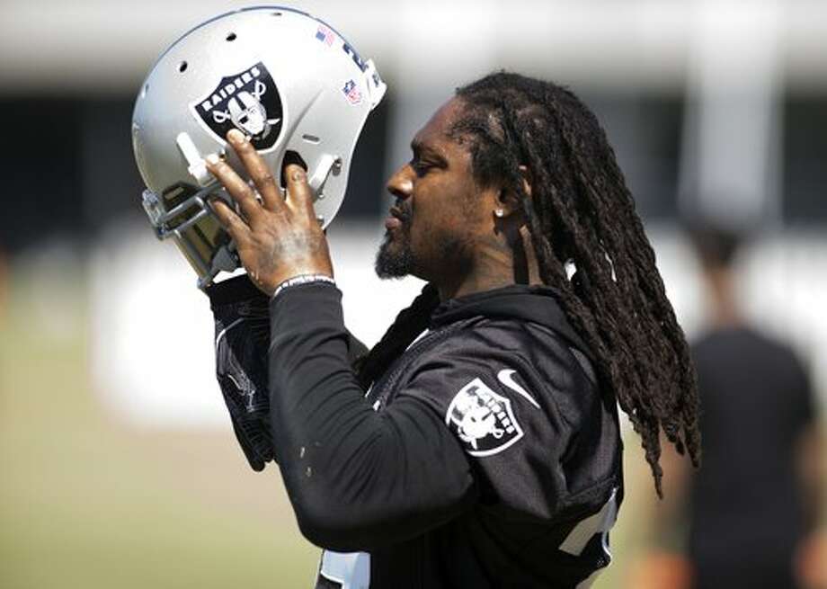 Oakland Raiders running back Marshawn Lynch dons his helmet for a workout at the team's training camp, on Thursday, Aug. 17, 2017 in Napa, Calif. Photo: D. Ross Cameron / Special To The Chronicle
