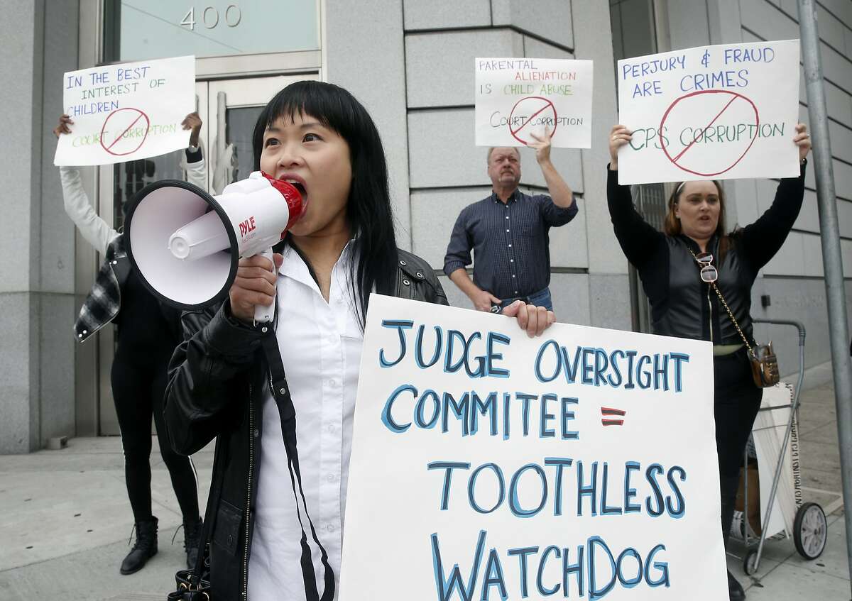 Michelle Chan, from Parents Against CPS Corruption, leads a protest in front of the Superior Court building on McAllister Street in San Francisco, Calif. on Thursday, Aug. 17, 2017 before a judge hears final arguments from attorneys representing the state auditor's office and the Commission on Judicial Performance to decide if the commission should be forced to turnover decades of confidential judicial complaints.