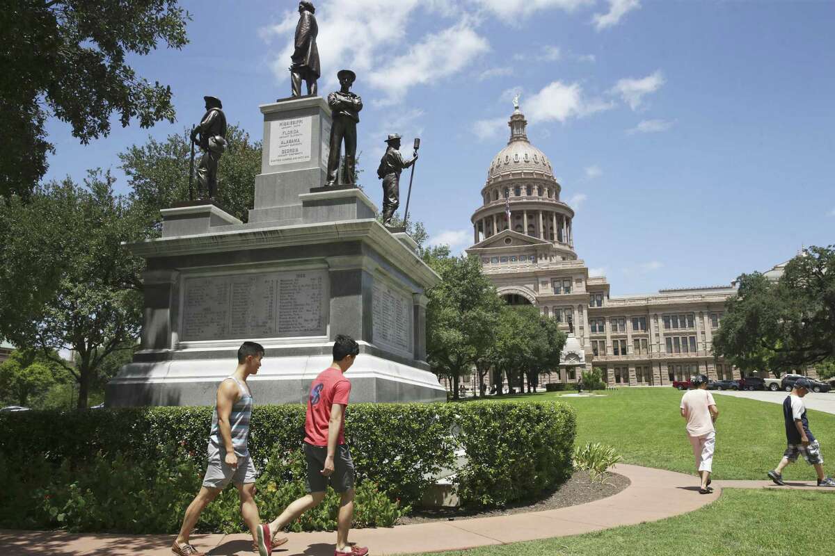 Tourist proceed around the huge Confederate monument to Texas Civil War veterens located at the south entrance to the Capitol grounds on August 16, 2017.
