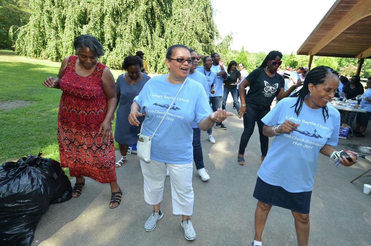 Tressie Hinton, center, gets people line dancing during the Calvary Baptist Church picnic at Cranbury Park on Sunday, Aug. 13, in Norwalk. Parishioners enjoyed food, games, music and more during the annual event for the Norwalk church.