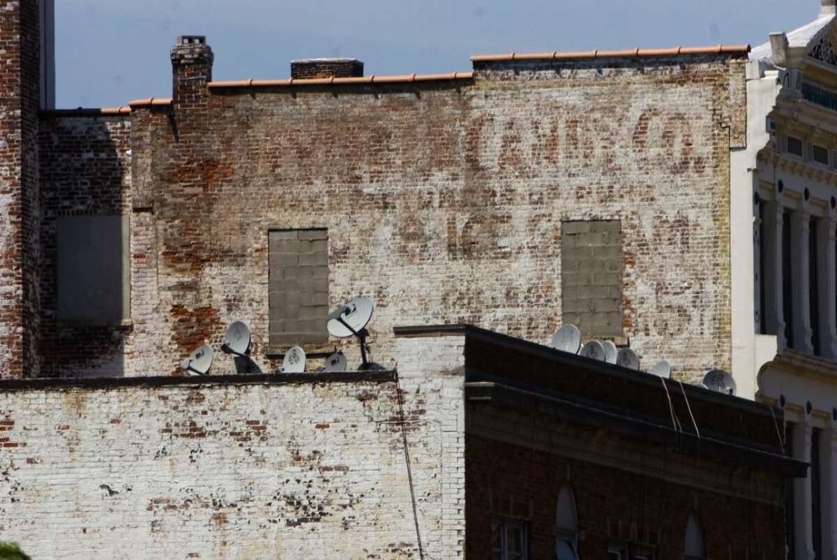 Jonathan Reiss, who's blog is called Streets of Stamford, has found buildings with old painted signs throughout the city. An old candy sign sits on a wall along Atlantic Street in Stamford, Conn. on Friday June 18, 2010.