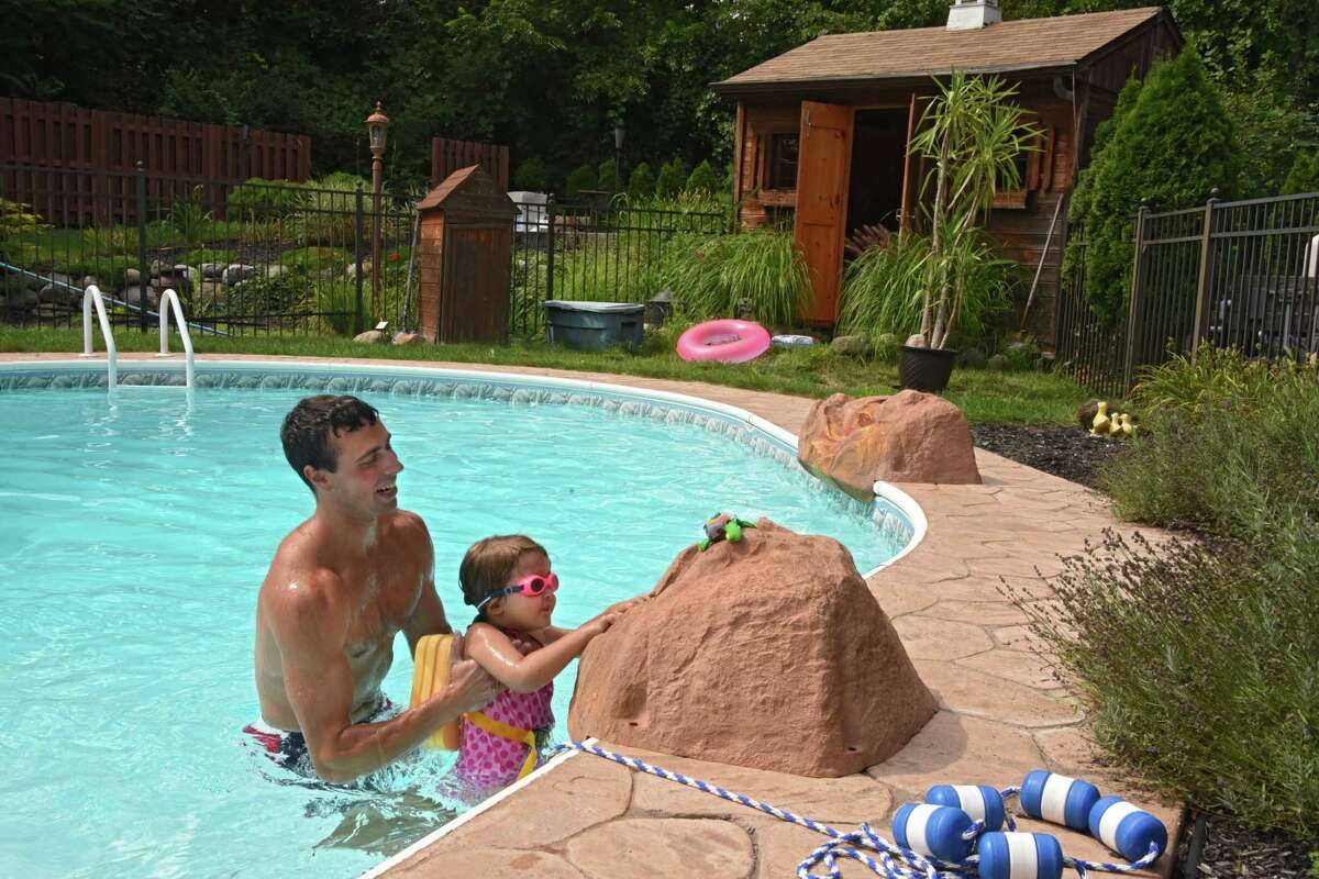 Thomas Kearney teaches Charlotte Smith, 3, how to swim at her home on Tuesday, Aug. 15, 2017 in Clifton Park, N.Y. (Lori Van Buren / Times Union)